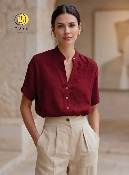 May include: A deep burgundy short-sleeved shirt with a mandarin collar, a V-neckline, and light-colored buttons, paired with high-waisted beige trousers featuring front pleats. The image includes a yellow smiley face logo and the text YUYE STORE.