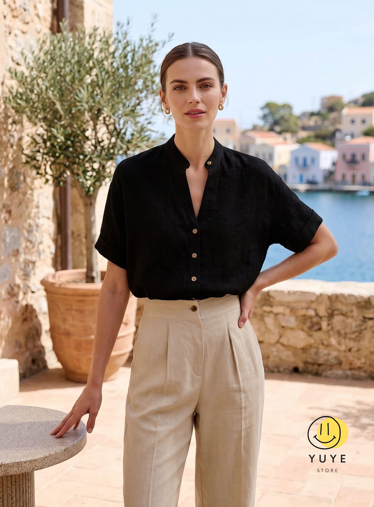 May include: A black short-sleeved button-down shirt with a mandarin collar paired with high-waisted beige trousers featuring front pleats. The shirt has light-colored buttons down the front. A yellow circular logo with a smiley face and the text YUYE STORE.