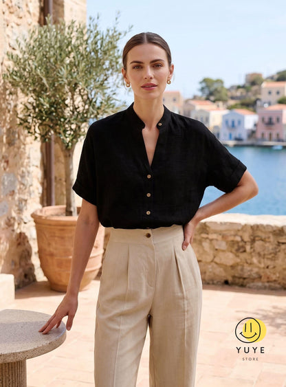 May include: A black short-sleeved button-down shirt with a mandarin collar paired with high-waisted beige trousers featuring front pleats. The shirt has light-colored buttons down the front. A yellow circular logo with a smiley face and the text YUYE STORE.