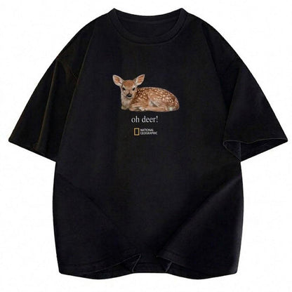 May include: A black short-sleeved t-shirt featuring a realistic graphic of a spotted fawn lying down. Below the fawn, the text reads "oh deer!" in a white serif font, followed by the National Geographic logo with its signature yellow rectangle.
