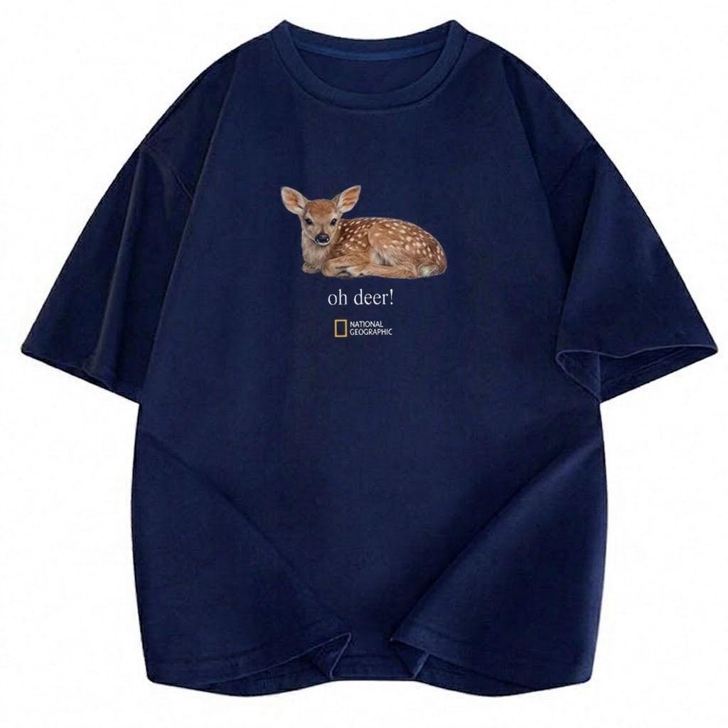 May include: A navy blue short-sleeve t-shirt featuring a graphic of a spotted fawn lying down. Below the fawn, the text reads "oh deer!" followed by the National Geographic logo. The shirt has a crew neckline and a relaxed, loose-fitting silhouette.
