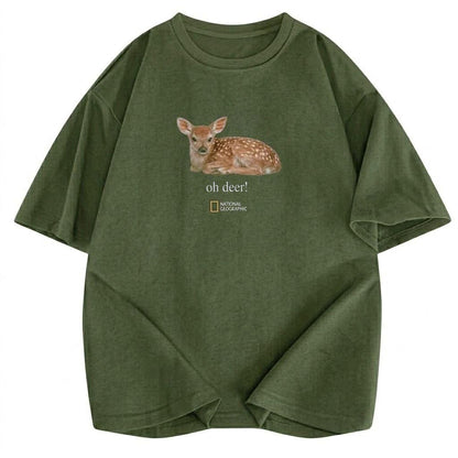 May include: An olive green short-sleeve t-shirt featuring a graphic of a spotted fawn lying down. Below the fawn, the text reads "oh deer!" followed by the National Geographic logo. The shirt has a crew neckline and a relaxed, boxy fit.