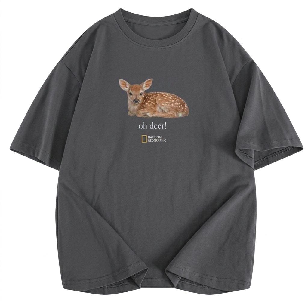 May include: A charcoal gray short-sleeve t-shirt featuring a graphic of a spotted fawn lying down. Below the fawn, the text reads "oh deer!" followed by the National Geographic logo. The shirt has a crew neckline and a relaxed, boxy fit.