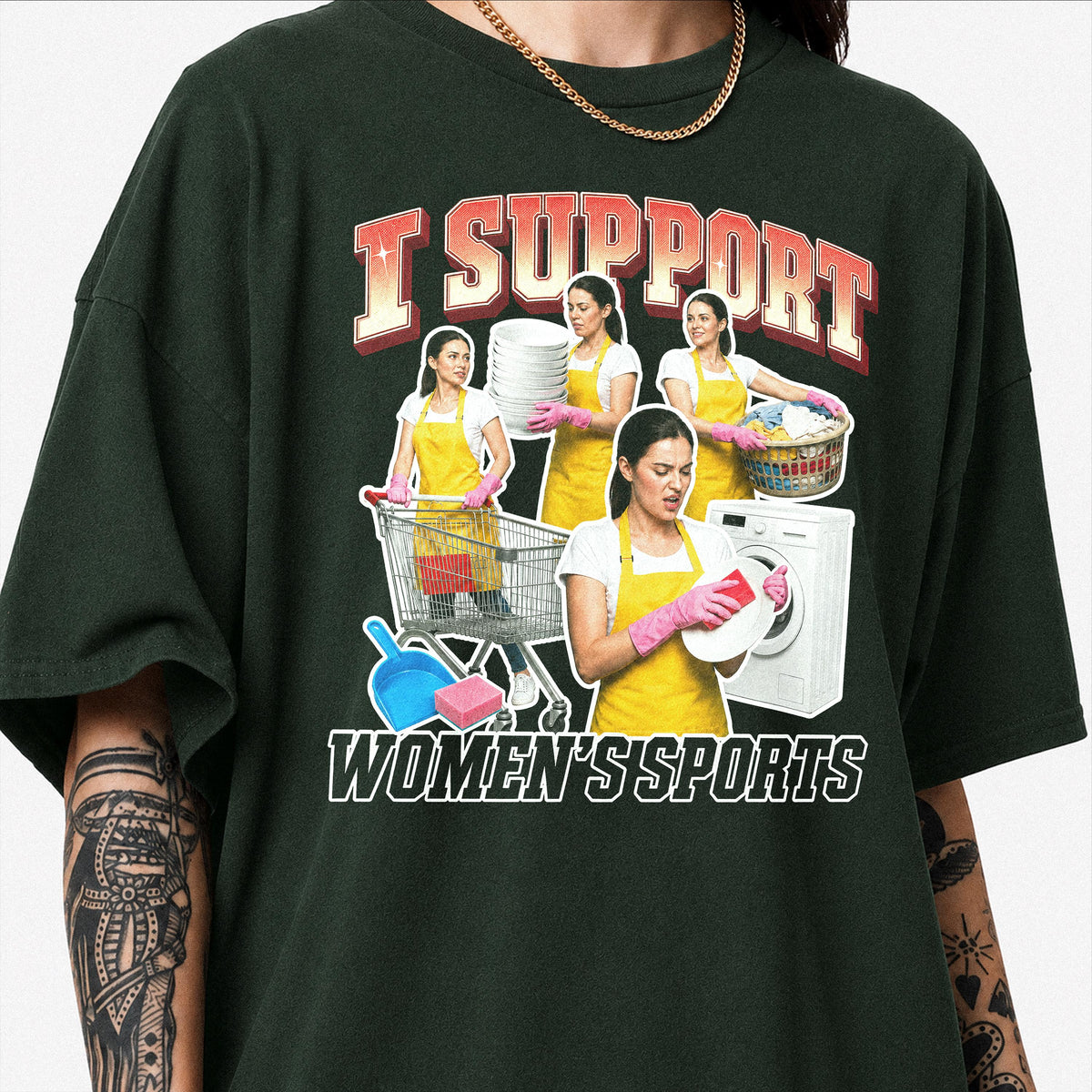 May include: A dark green t-shirt featuring a graphic print with the text I SUPPORT WOMEN'S SPORTS. The design shows a person in a yellow apron and pink gloves performing household chores like laundry, dishwashing, and shopping with a cart.