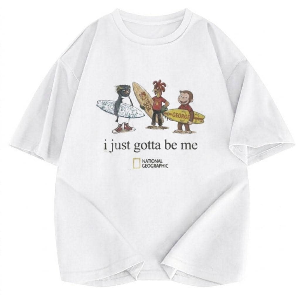 May include: A white short-sleeved t-shirt featuring a graphic of a penguin, a chicken, and a monkey holding surfboards. Below the characters, the text reads "i just gotta be me" followed by the National Geographic logo in a yellow rectangular frame.