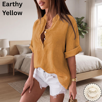 May include: An earthy yellow button-down shirt with a mandarin collar and cuffed short sleeves, paired with white denim shorts. The text "Earthy Yellow" appears in the upper left corner, and a circular "Monelle" logo is in the bottom right.