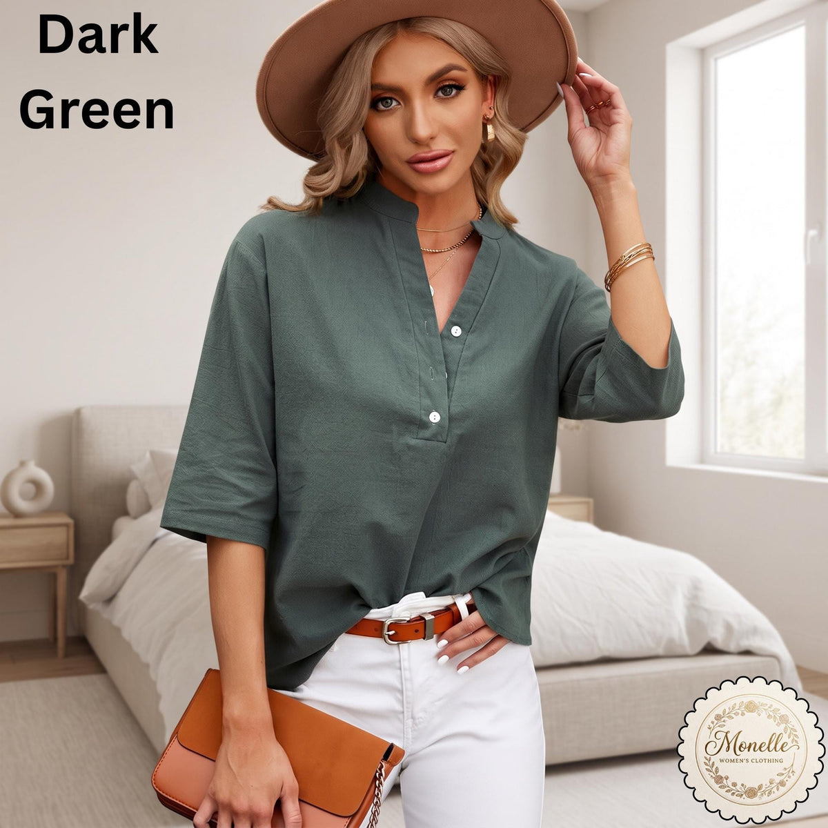 May include: A dark green shirt with a V-neckline, a partial button-down front, and three-quarter length sleeves. The shirt is paired with white pants, a brown belt with a silver buckle, and a tan wide-brimmed hat. A tan handbag is held in front.