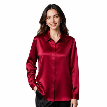 May include: A long-sleeved button-down shirt in a deep red satin fabric with a smooth, reflective finish. The shirt features a classic collar, a front button placket, and cuffed sleeves, providing a structured yet fluid appearance in a solid color.