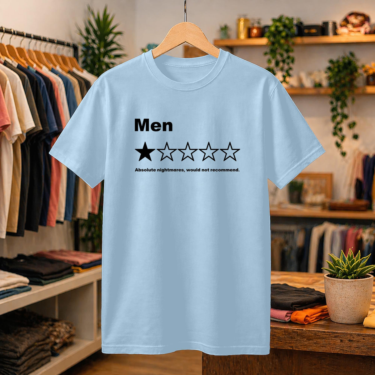 May include: A light blue short-sleeved t-shirt featuring the word Men in black text above a single filled-in star and four empty stars, followed by the text Absolute nightmares, would not recommend. printed in black on the chest area.