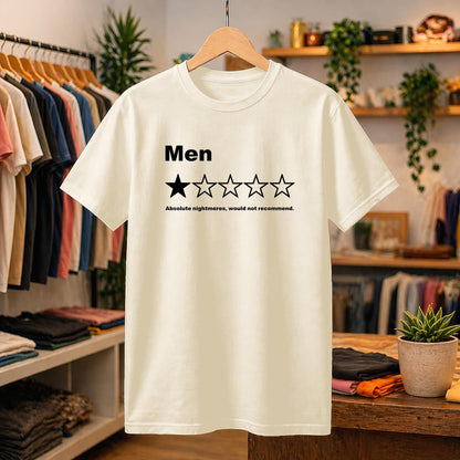 May include: A cream-colored short-sleeve t-shirt featuring the black text 'Men' above a five-star rating graphic with only one star filled in. Below the stars, the black text reads 'Absolute nightmares, would not recommend.'