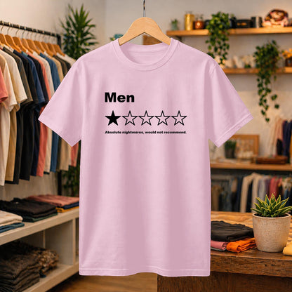 May include: A light pink short-sleeved t-shirt featuring the black text 'Men' above a graphic of five stars, with only the first star filled in black. Below the stars, the text reads 'Absolute nightmares, would not recommend.'