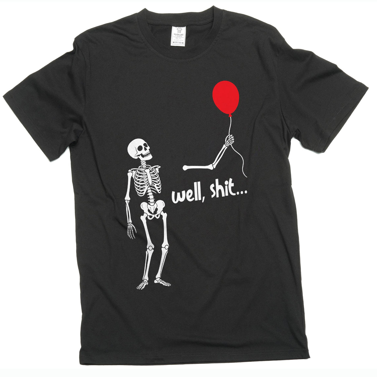 May include: A black short-sleeve t-shirt featuring a white graphic of a skeleton looking up at a detached skeletal arm holding a red balloon. The text "well, shit..." is printed in white letters below the arm, centered on the chest area.