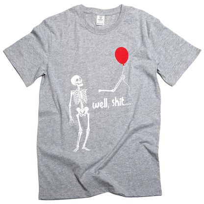 May include: A heather gray short-sleeve t-shirt featuring a white graphic of a skeleton looking up at a red balloon held by a detached skeletal arm. The text "well, shit..." is printed in white below the arm. The shirt has a crew neckline.