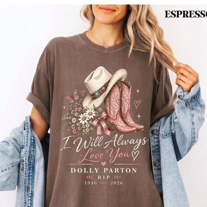 May include: A brown short-sleeve t-shirt featuring a graphic of a white cowboy hat, pink cowboy boots, a butterfly, and a bouquet of flowers. The text reads: I Will Always Love You, DOLLY PARTON, RIP, 1946-2026, with small heart icons.