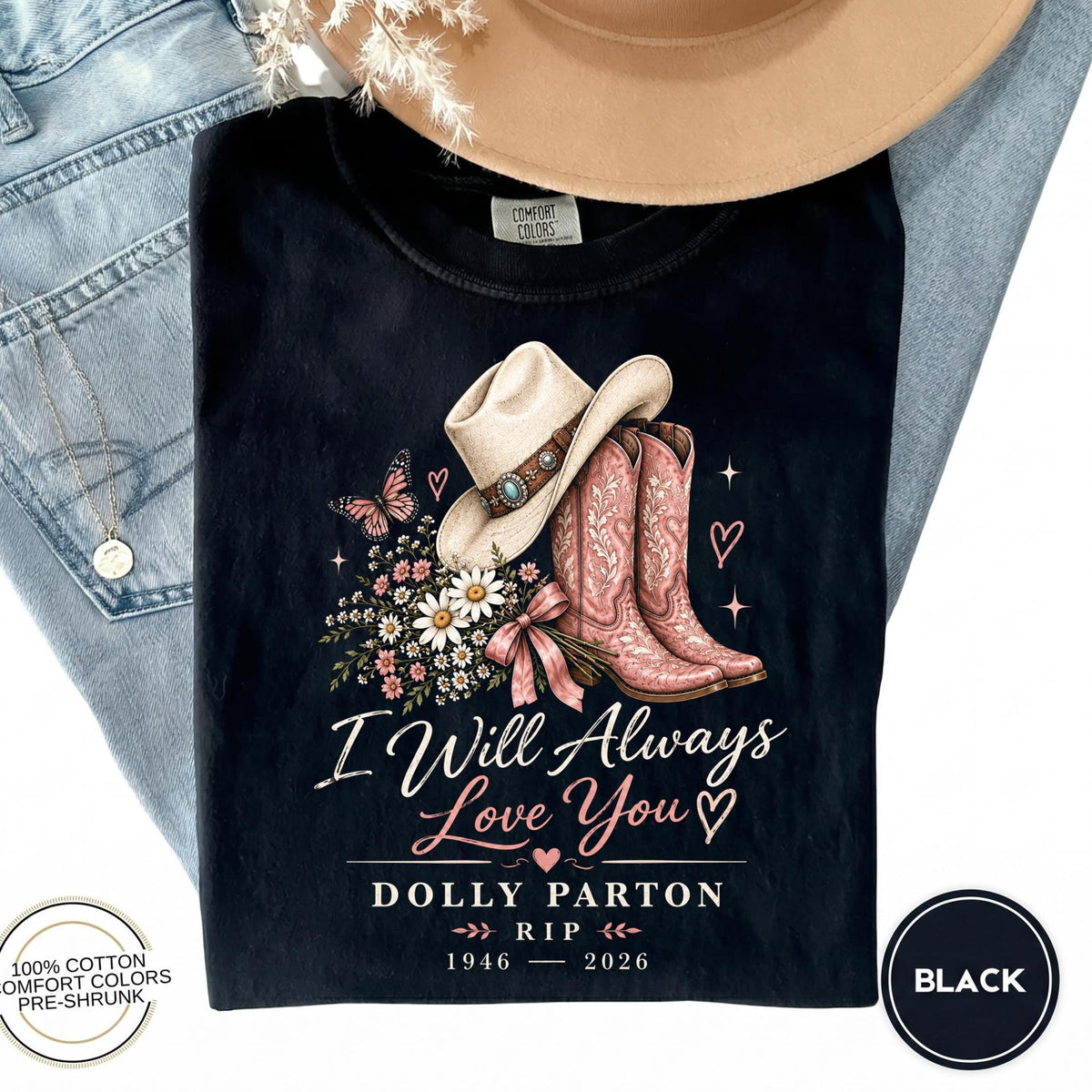 May include: A black t-shirt featuring a graphic of a cowboy hat, pink cowboy boots, and a bouquet of flowers. The text reads I Will Always Love You, DOLLY PARTON, RIP, 1946-2026. The design includes small hearts, a butterfly, and sparkles.