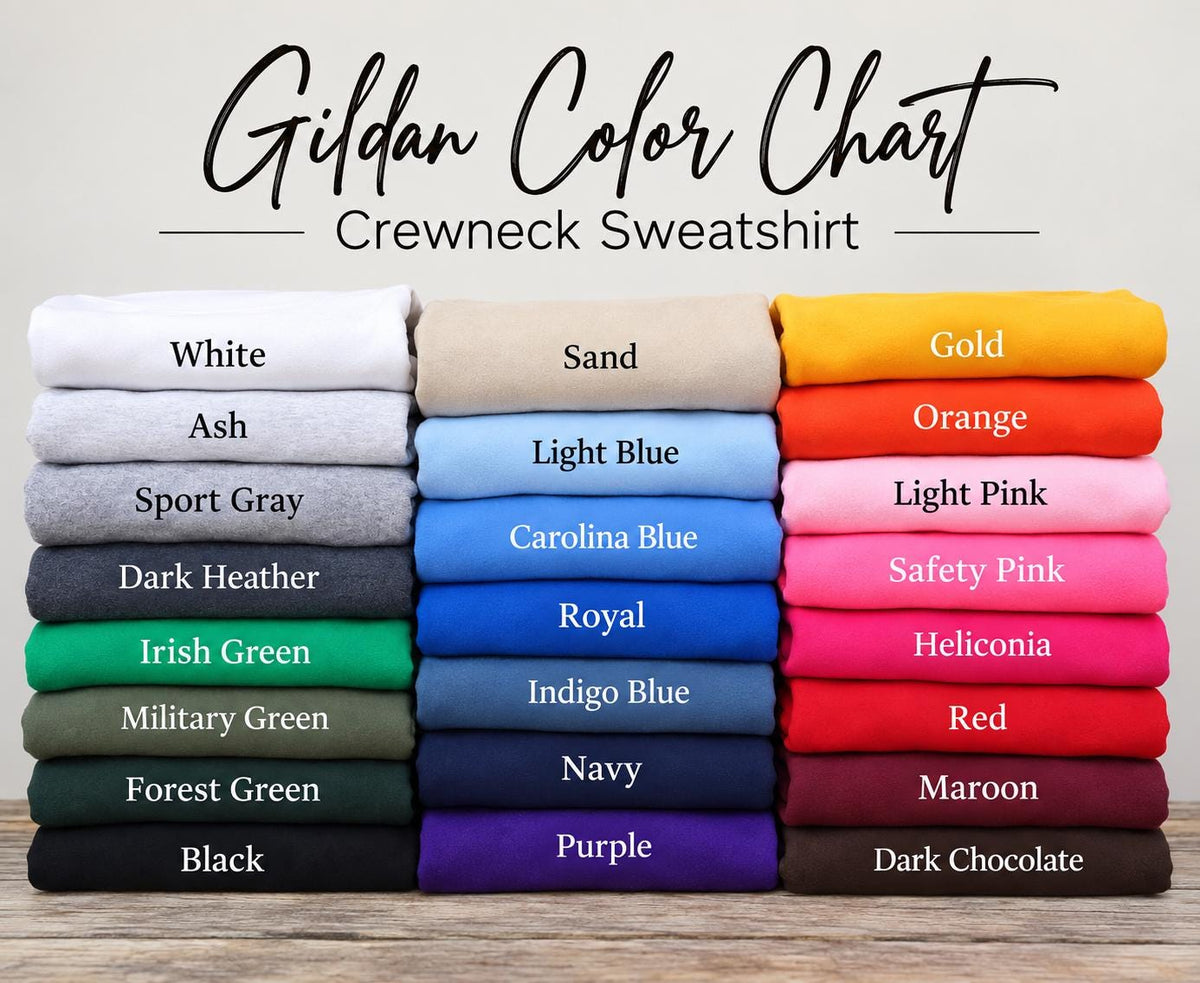 May include: A Gildan Color Chart for crewneck sweatshirts featuring three vertical stacks of folded fabric in various colors. The text reads Gildan Color Chart Crewneck Sweatshirt, with labels for each color including White, Ash, Sport Gray, Dark Heather, Irish Green, Military Green, Forest Green, Black, Sand, Light Blue, Carolina Blue, Royal, Indigo Blue, Navy, Purple, Gold, Orange, Light Pink, Safety Pink, Heliconia, Red, Maroon, and Dark Chocolate.