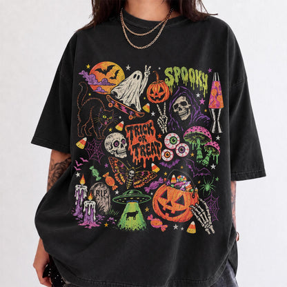 May include: A black short-sleeve t-shirt featuring a colorful graphic print of Halloween-themed imagery including a ghost on a skateboard, a pumpkin, a skull, a lava lamp, a moth, a UFO, and the text "SPOOKY" and "TRICK OR TREAT" in a dripping font.