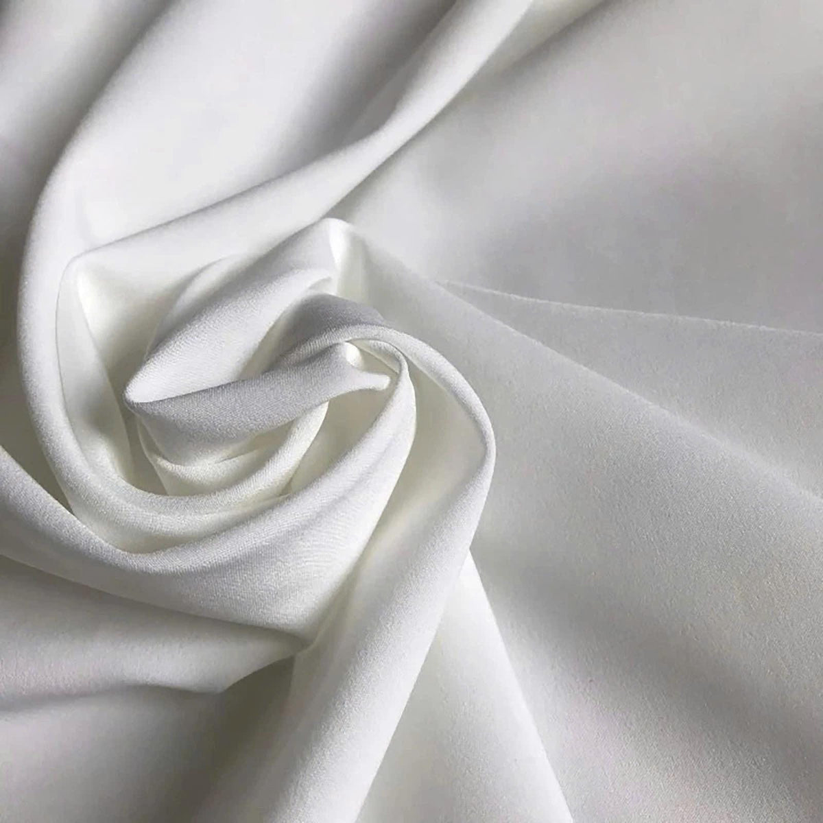 May include: A solid white fabric with a smooth, matte texture, draped in soft, flowing folds that create deep shadows and highlights across the surface. The material appears opaque and consistent in color, showcasing a clean, neutral aesthetic.