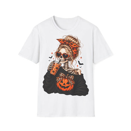 A white t-shirt centered with a graphic of a skeleton woman with a bun and orange patterned headband wearing heart-shaped sunglasses and drinking from a cup.