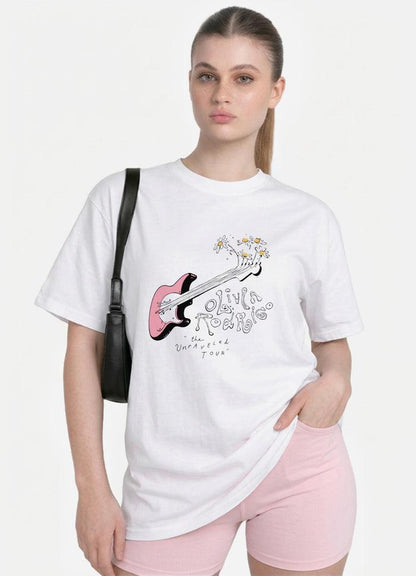 May include: A white short-sleeved t-shirt featuring a graphic of a pink electric guitar with daisies sprouting from the headstock. The text reads Olivia Rodrigo and the Unraveled Tour in a stylized font. A black shoulder bag is worn on the side.