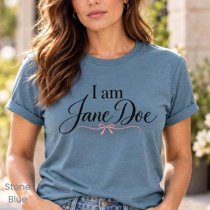A woman wearing a blue t-shirt with the text "I am Jane Doe" printed on it.