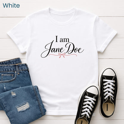 A white t-shirt with the text "I am Jane Doe" printed on it, along with a pair of blue jeans and black and white sneakers.
