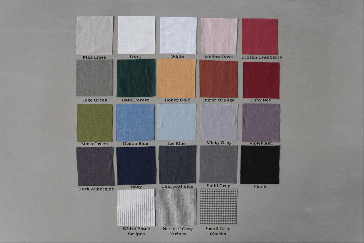 May include: Swatch card showing 20 different fabric colors and patterns. The colors include flax linen, ivory, white, mellow rose, frozen cranberry, sage green, dark forest, honey gold, burnt orange, ruby red, moss green, ocean blue, ice blue, misty grey, violet ash, dark aubergine, navy, charcoal blue, solid grey, and black. The patterns include white black stripes, natural grey stripes, and small grey checks.