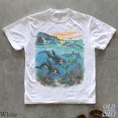 White T-shirt with orcas, dolphins and sea turtles graphic