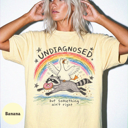 Undiagnosed But Something Ain't Right Shirt, Funny Goose Riding Raccoon Tee, Comfort Colors Silly Goose T-Shirt, Mental Health Humor Gift